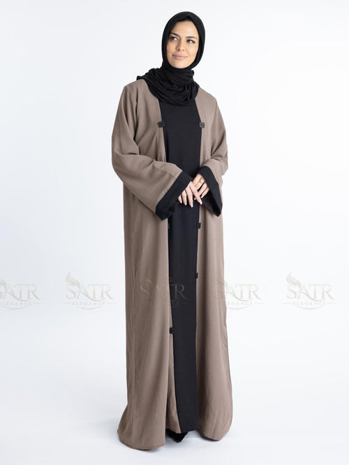 Women with dual tone Abaya black in middle and brown on both sides with white background. Clean and elegant look for casual occasions.