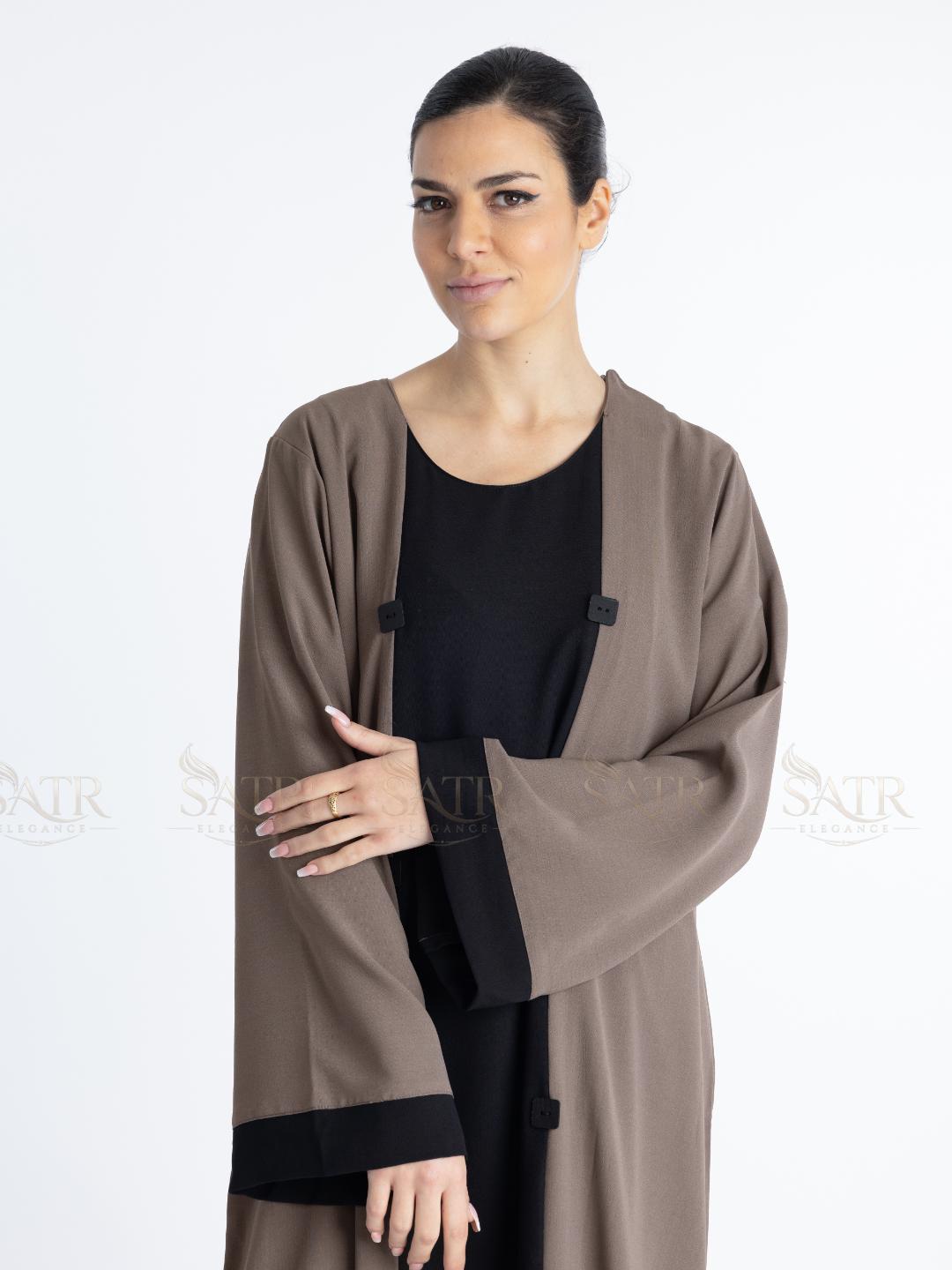 Women with dual tone Abaya black in middle and brown on both sides with white background. Clean and elegant look for casual occasions. Show-casing black and brown combination style on sleeves.