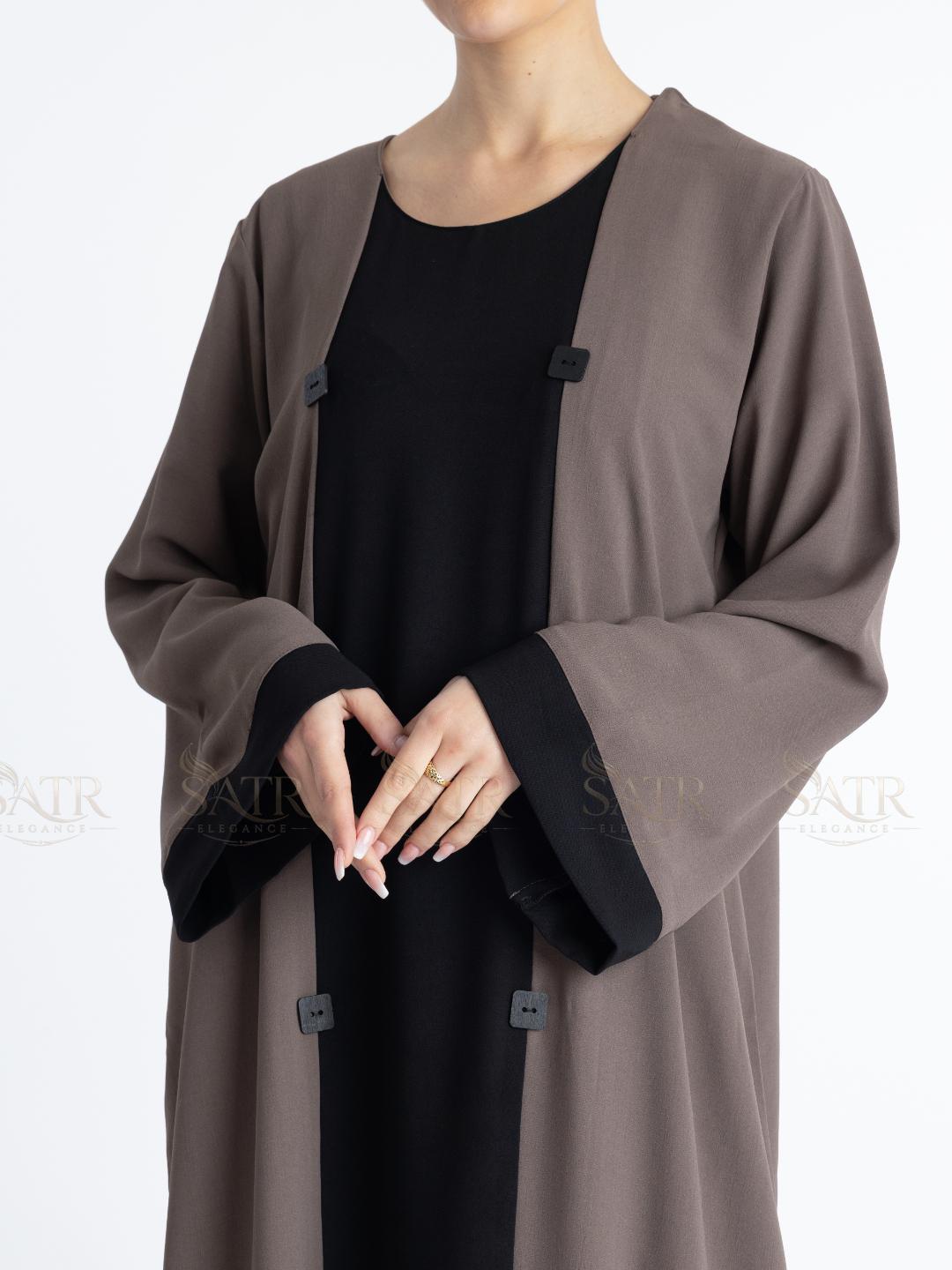 Women with dual tone Abaya black in middle and brown on both sides with white background. Clean and elegant look for casual occasions.
