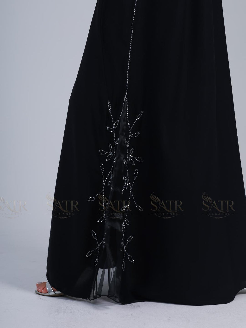 Premium black dress with silver embroidery on a light gray background