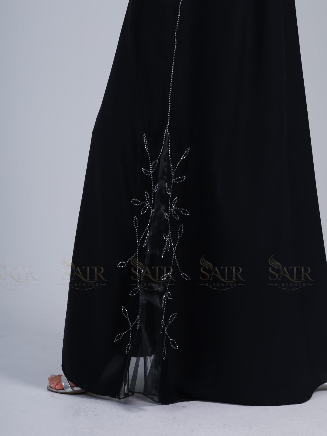 Premium black dress with silver embroidery on a light gray background