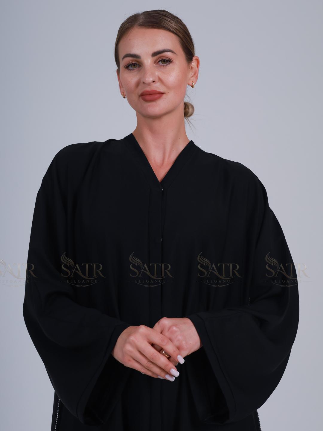 Woman wearing a black robe with 'SATR' branding on a gray background