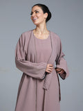 Women wearing pink abaya with small work on front pattern and grey background.
