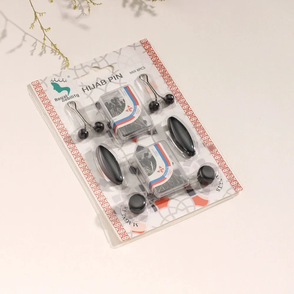 Packaged set of black hair pins on a decorative card with visible branding.